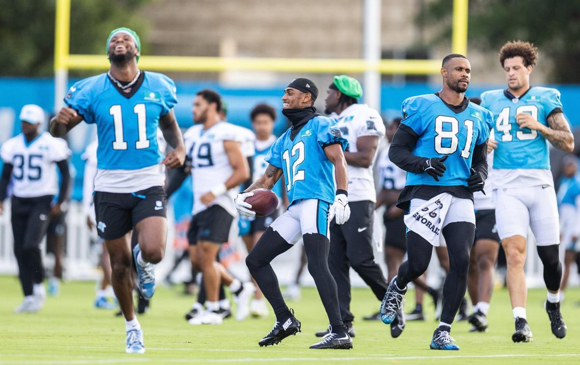 Carolina Panthers players share a laugh during the Carolina Panthers Training Camp in Charlotte, N.C., on Monday, August 5, 2024.