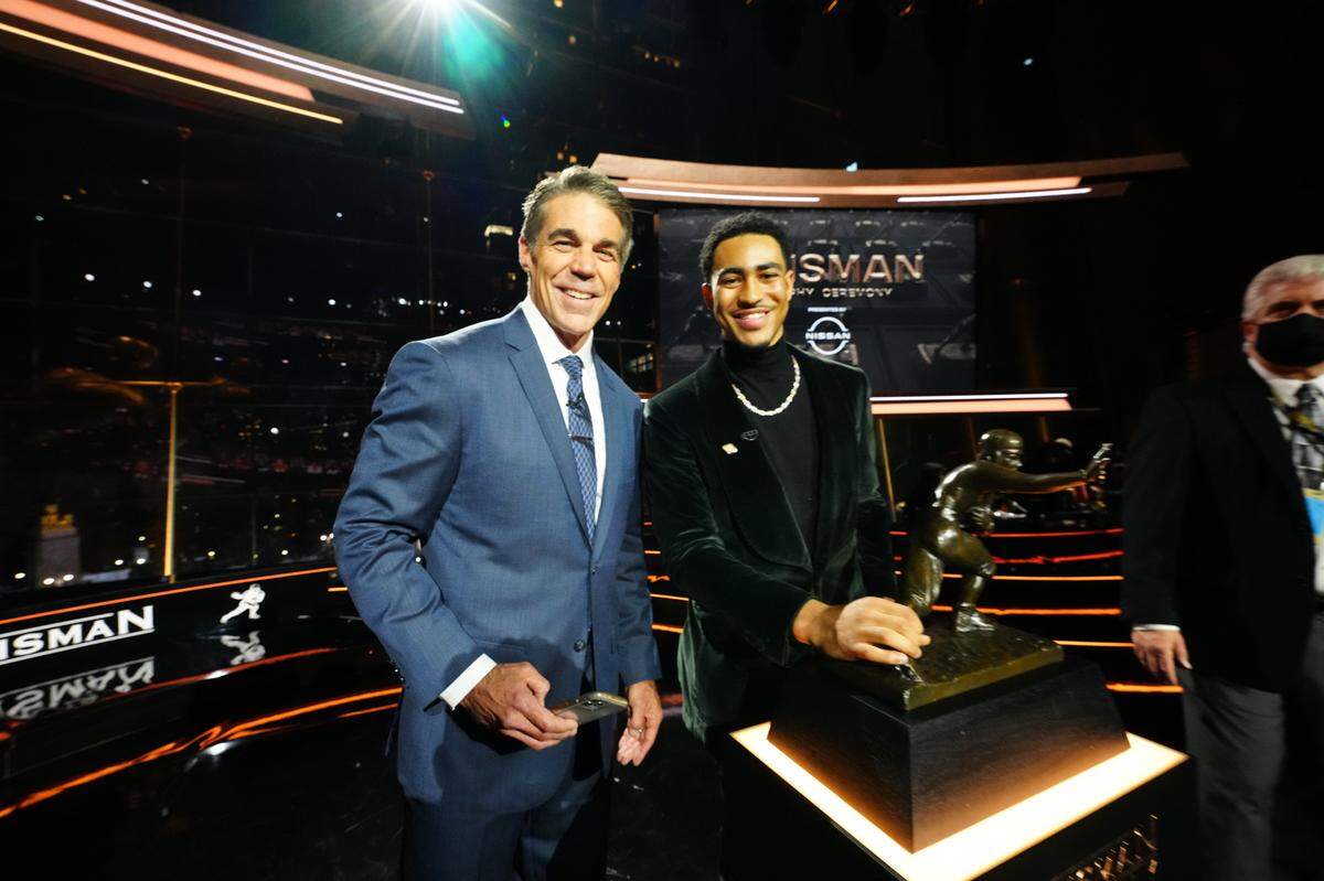 Chris Fowler (left) with Bryce Young of the University of Alabama during the 2021 Heisman Trophy presentation ceremony on Dec. 11, 2021, in New York. Young won the Heisman, then became the Carolina Panthers’ No. 1 overall draft pick in April 2023. Fowler will call Young’s “Monday Night Football” debut on ESPN Monday.