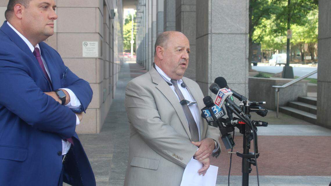 Attorney Ronald Shook, left, and Paul Valone, president of Grass Roots North Carolina, right, speaking in front of media Thursday about the lawsuit they filed against Mecklenburg County Sheriff Garry McFadden. 