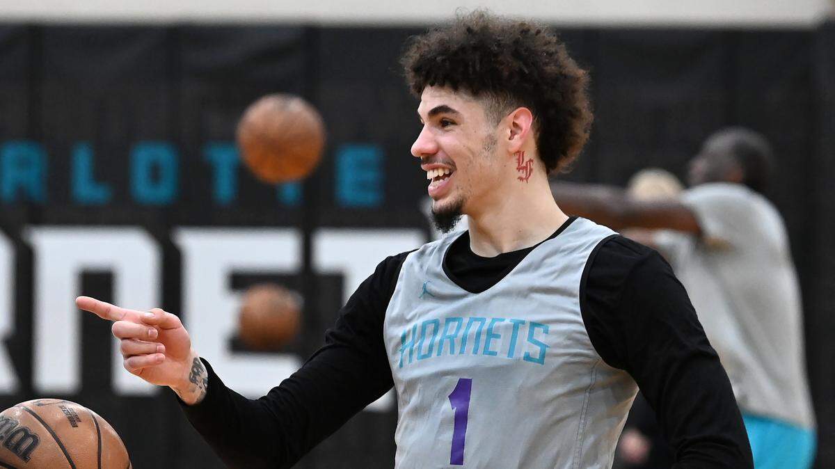 Charlotte Hornets guard LaMelo Ball jokes with a coach during practice on Thursday, November 16, 2023.