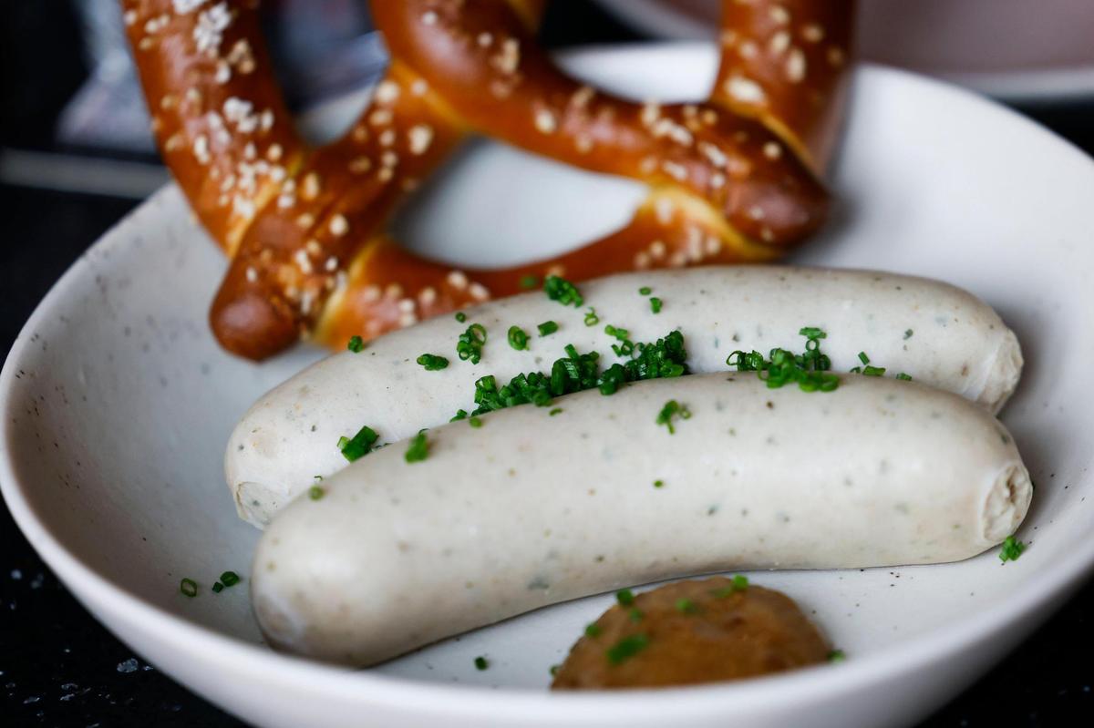 The Weisswurst, a herb-packed poached Bavarian white sausage with a house-made pretzel and Bavarian sweet mustard, at Gilde Brewery in Charlotte.