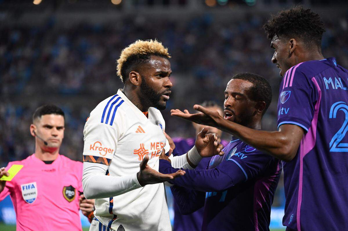 Mar 30, 2024; Charlotte, North Carolina, USA; FC Cincinnati forward Aaron Boupendza (9) and Charlotte FC defender Adilson Malanda (29) argue in the second half at Bank of America Stadium. Mandatory Credit: Bob Donnan-USA TODAY Sports