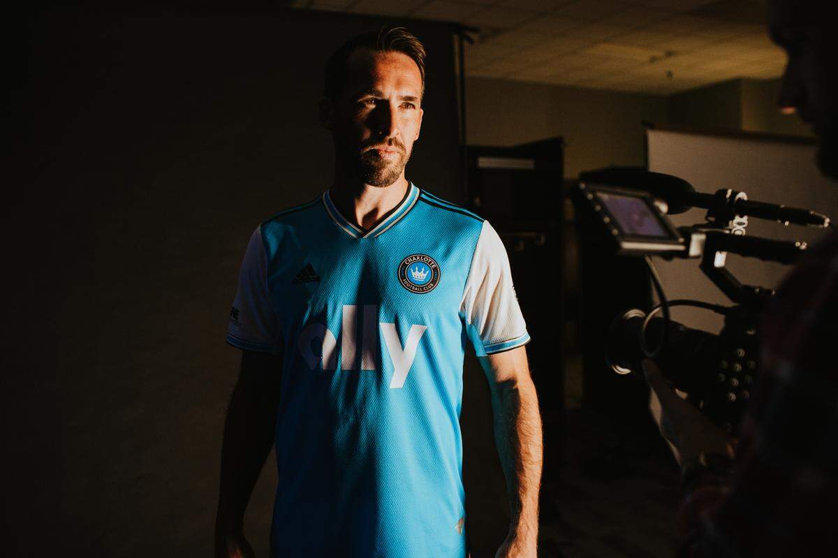Charlotte FC player Christian Fuchs poses in the team’s inaugural primary uniform, which was unveiled Dec. 9, 2021.