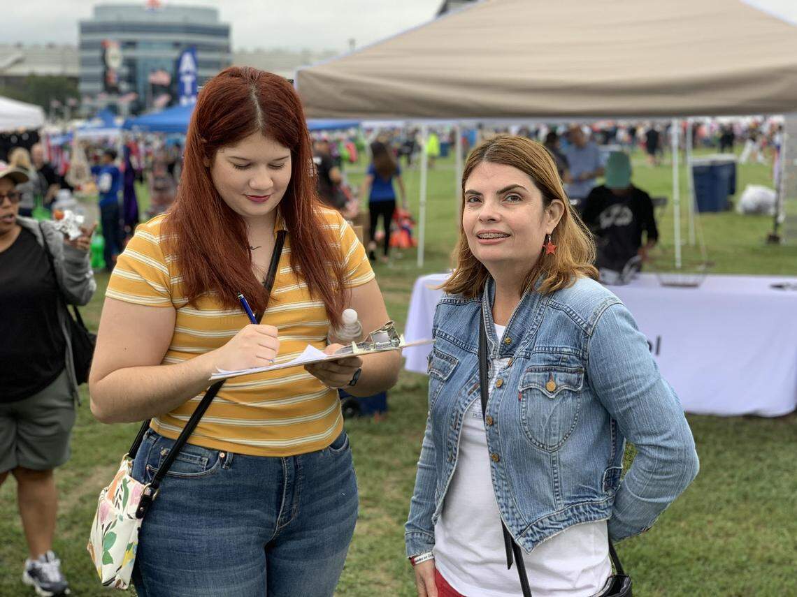 Irlanda Ruiz, a volunteer with Action NC, with María Cristina Pérez of Gastonia at an event in Concord in August. Ruiz was registering people to vote and updating their addresses.