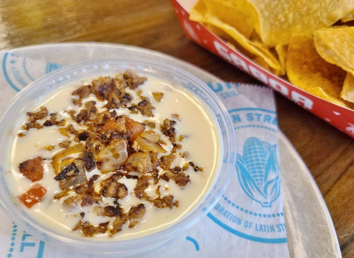 Creamy queso topped with spicy chorizo served with house-made chips, from Sabor Latin Grill’s secret menu.