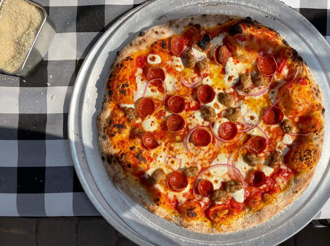 This pie from Bird Pizzeria features mozzarella, pepperoni, sausage and red onions.