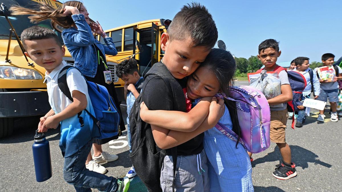 Sterling Elementary School kindergarten Axel Guevara Villanueva, left, hugs Mackenzie Sanchez Alvarado, right, as they say goodbye to one another before boarding the school buses to begin his summer break on Friday, June 9, 2023.
