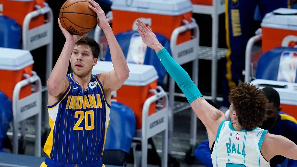 Indiana Pacers’ Doug McDermott (20) shoots against Charlotte Hornets’ LaMelo Ball (2) during the first half of an NBA basketball Eastern Conference play-in game Tuesday, May 18, 2021, in Indianapolis. (AP Photo/Darron Cummings)