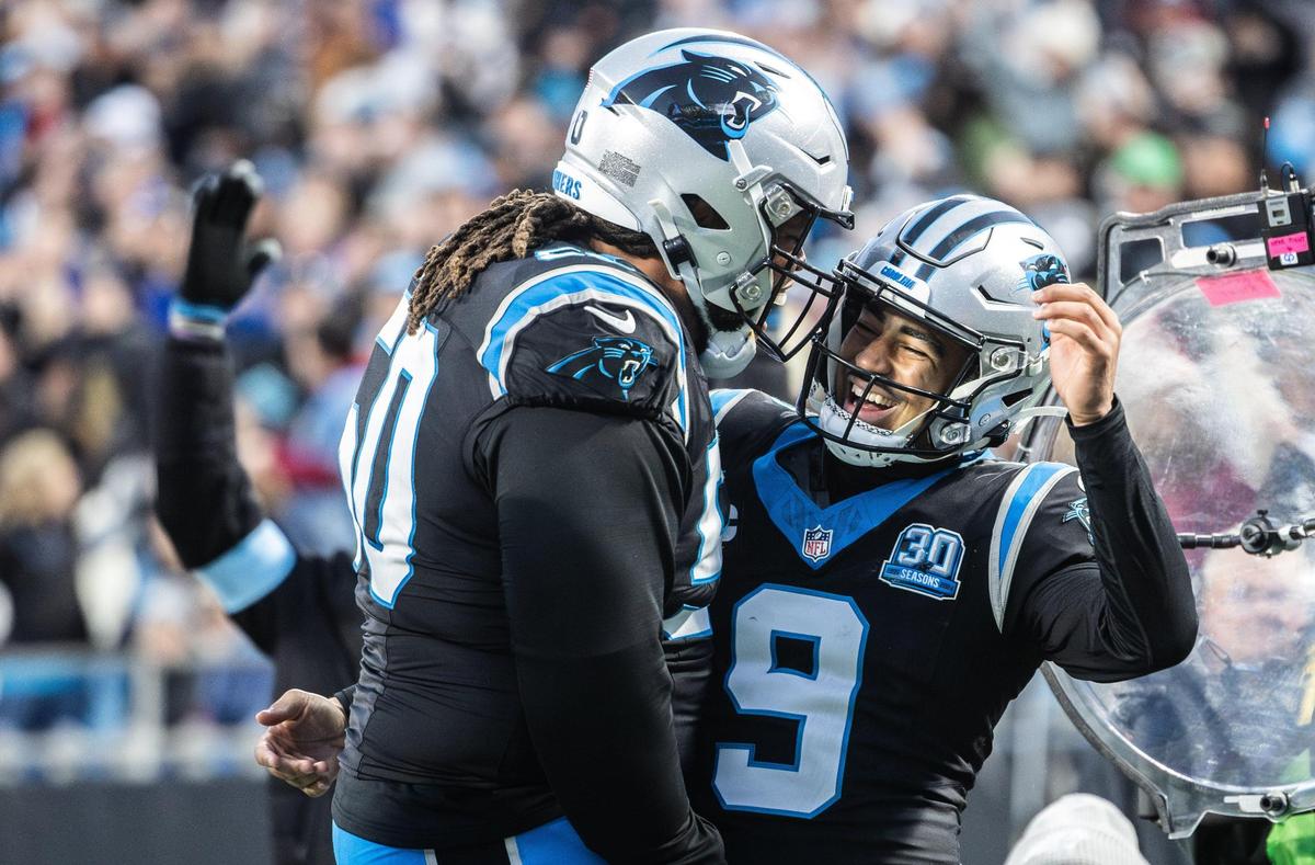 Carolina Panthers quarterback Bryce Young, right, celebrates a touchdown with Carolina Panthers guard Robert Hunt at the Bank of America Stadium in Charlotte, N.C., on Sunday, December 1, 2024.
