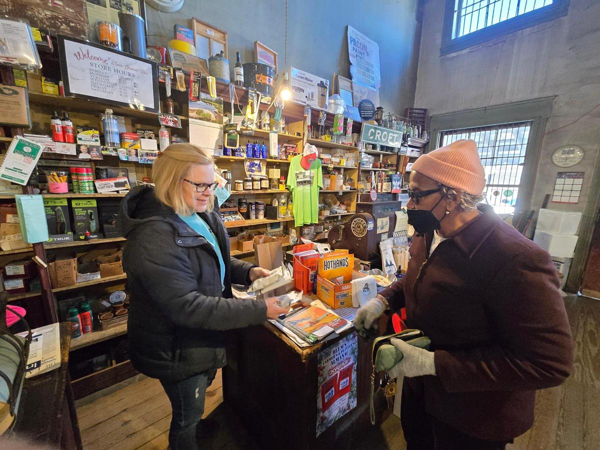 Noelle Small helps a customer at the Davis General Store. The business continues to turn down offers from real estate companies.