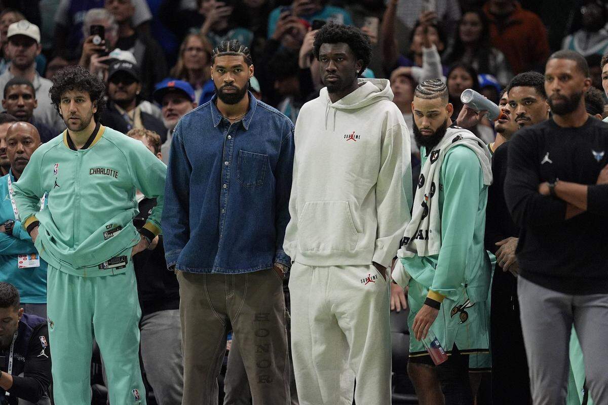 Nov 16, 2024; Charlotte, North Carolina, USA; Charlotte Hornets guard Vasilije Mici, center Nick Richards, center Mark Williams, forward Cody Martin, and head coach Charles Lee watch the final seconds against the Milwaukee Bucks during the second half at Spectrum Center. Mandatory Credit: Jim Dedmon-Imagn Images