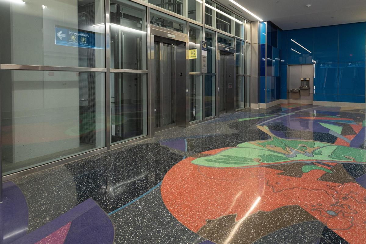 Carolina Moon, an artwork by Scott Parsons, embedded in the floor of the subterranean pedestrian walkway that connects parking and other activities to the terminal at Charlotte Douglas International Airport. Photo from Thursday, July 21, 2022.