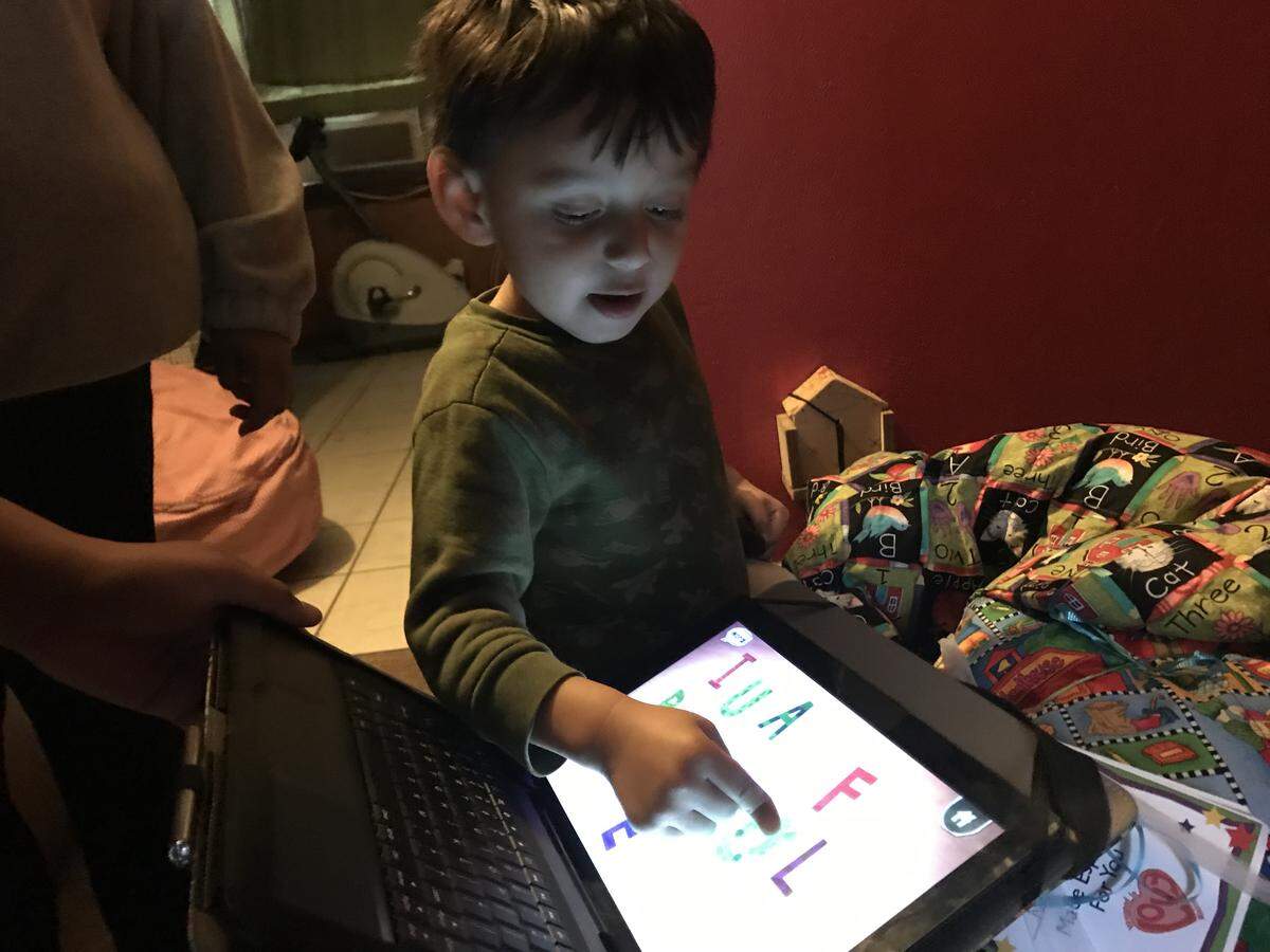 Nelson Moran, 3, gets his first look at a new tablet loaded with learning apps for children with autism. The tablet was donated by a Charlotte Observer reader who was inspired by reading an article about Nelson, who has autism.
