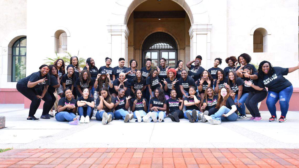 Black Girls Film Camp teen directors are seated in the front row, surrounded by camp creative coaches, editors, advisors coordinators and directors. They were all in Los Angeles last spring as part of a weekend retreat at USC.