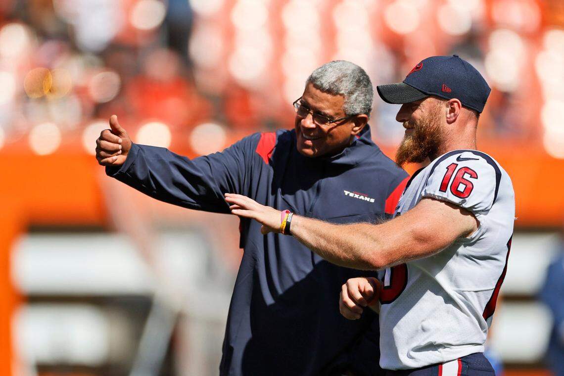 Former Houston Texans head coach David Culley, left, talks with kicker Joey Slye before an NFL football game against the Cleveland Browns, Sunday, Sept. 19, 2021, in Cleveland. (AP Photo/Ron Schwane)