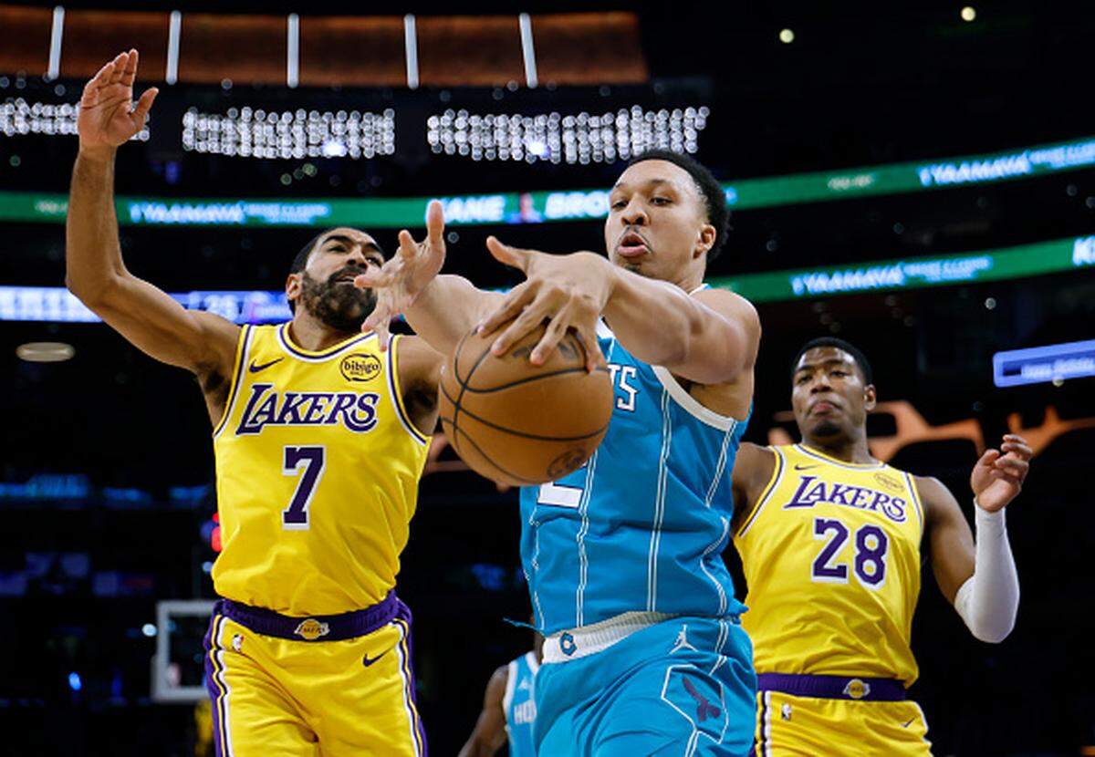 Grant Williams of the Charlotte Hornets grabs a rebound in front of Gabe Vincent and Rui Hachimura of the Los Angeles Lakers during Charlotte’s 135-117 Hornets win at Crypto.com Arena.