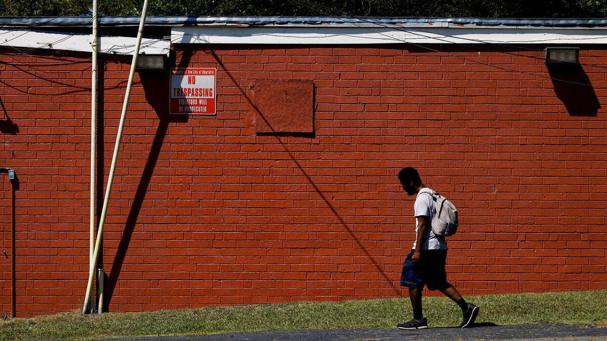 Johnny Alston of Durham walks past a wall of Parkwood Food Mart in east Charlotte Thursday, Sept. 1, 2022. The wall had a mural by artist Kyle Holbrook this week until the store owner painted over it.