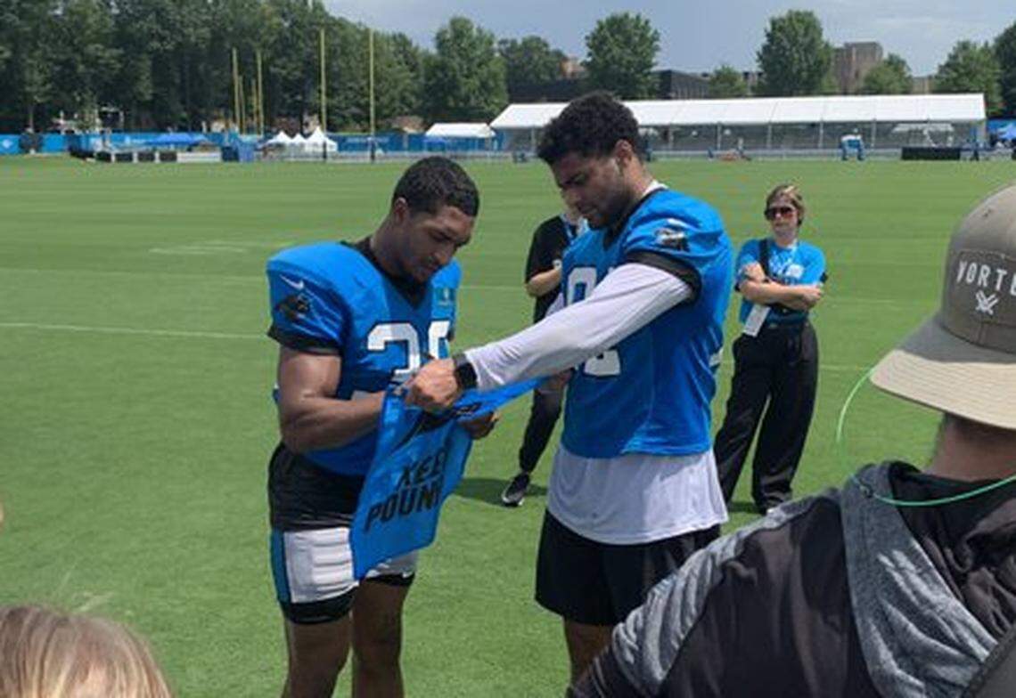 Carolina Panthers running back Chuba Hubbard and tight end Tommy Tremble sign autographs following the first day of padded practice outside of Bank of America Stadium in Charlotte, NC on Tuesday, July 30, 2024.
