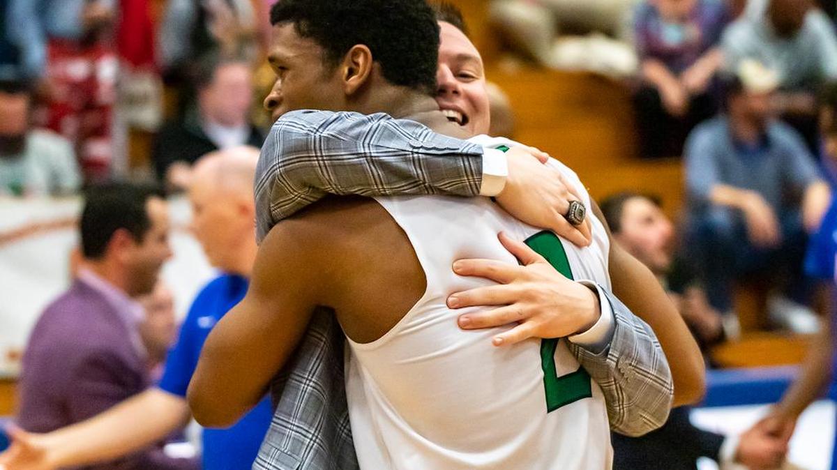 Chase Lowe and his coach embrace after they upset North Meck in the last minute