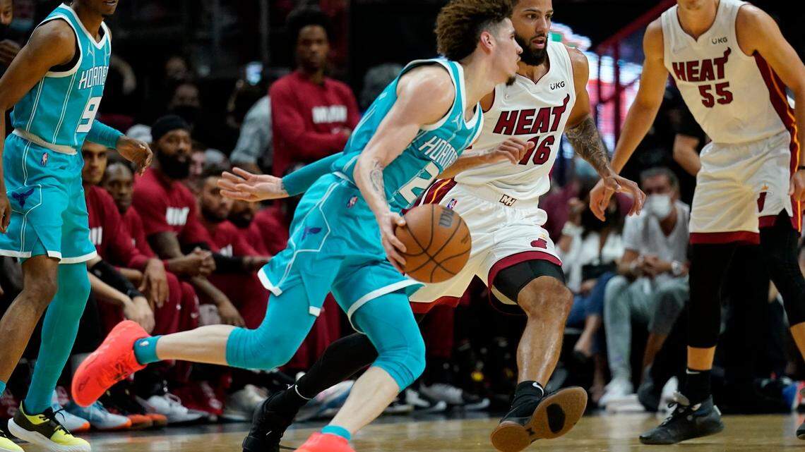 Charlotte Hornets guard LaMelo Ball (2) drives to the basket as Miami Heat forward Caleb Martin (16) defends during the first half of a preseason NBA basketball game, Monday, Oct. 11, 2021, in Miami. (AP Photo/Lynne Sladky)