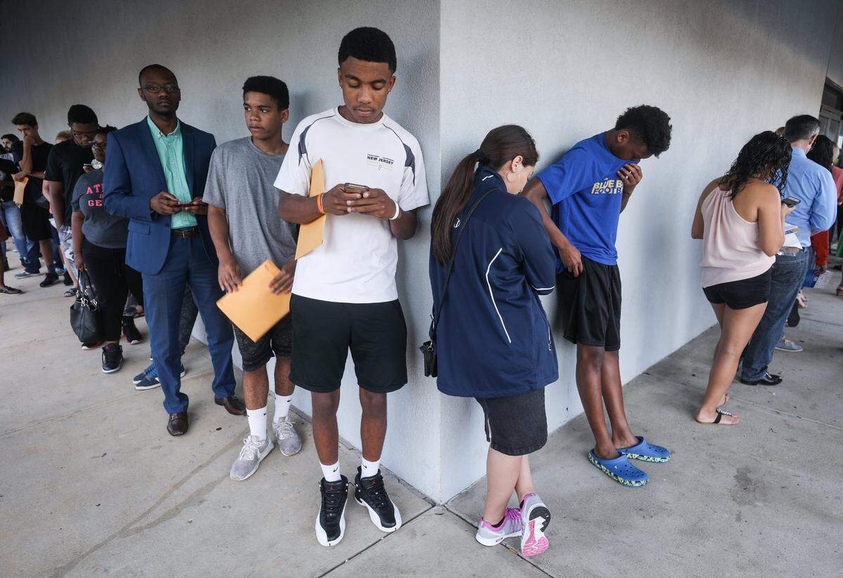 North Carolina residents wait inside a DMV office in Raleigh in 2018. The settlement of a longstanding N.C. lawsuit on Thursday, March 3, 2022, could restore suspended licenses for thousands of mostly poor and minority drivers.
