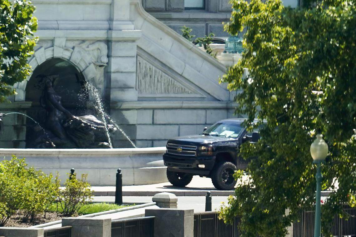 A pickup truck is parked on the sidewalk in front of the Library of Congress’ Thomas Jefferson Building, as seen from a window of the U.S. Capitol, Thursday, Aug. 19, 2021, in Washington. A man sitting in the pickup truck outside the Library of Congress has told police that he has a bomb, and that’s led to a massive law enforcement response to determine whether it’s an operable explosive device. (AP Photo/Alex Brandon)
