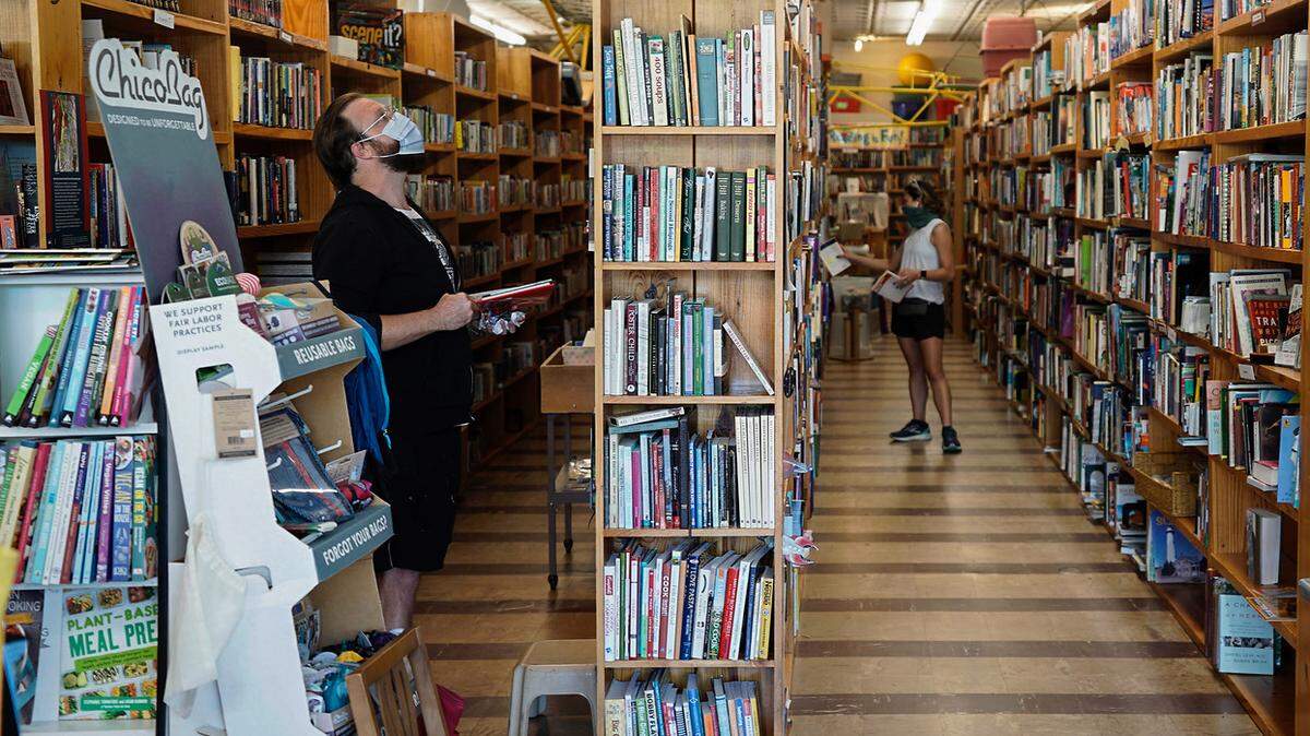 In this May 2020 photo, customers in Book Buyers on Central Avenue browse shelves. The used bookstore is a latest casualty of redevelopment in Plaza Midwood, but the owners say they plan to reopen in a new location about 2 miles away.