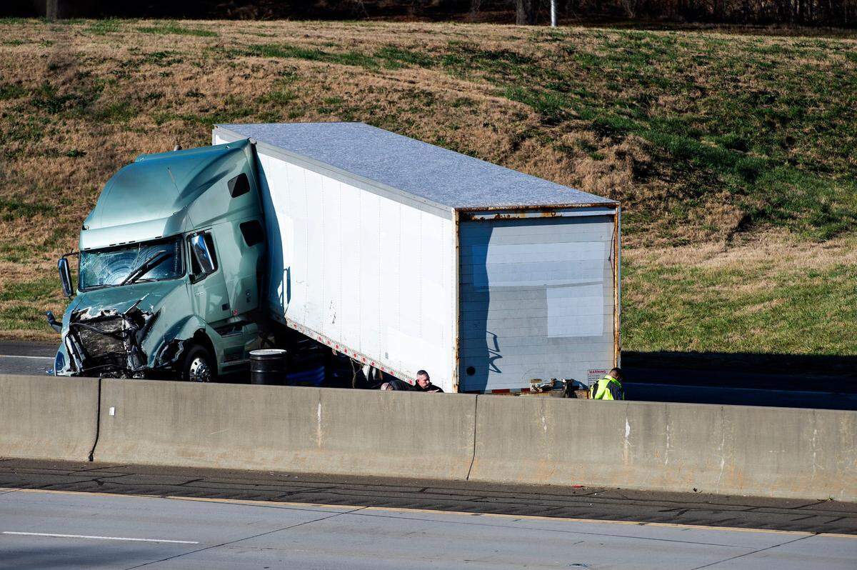 A tractor-trailer rests along southbound Interstate 85 near the WT Harris Boulevard exit, where a crash killed Charlotte-Mecklenburg police Officer Mia Goodwin and injured three others on Wednesday, December 22, 2021 in Charlotte, NC. Two trucks collided on the highway and crashed into the officers and their vehicles. CMPD charged one of the truckers on Thursday.
