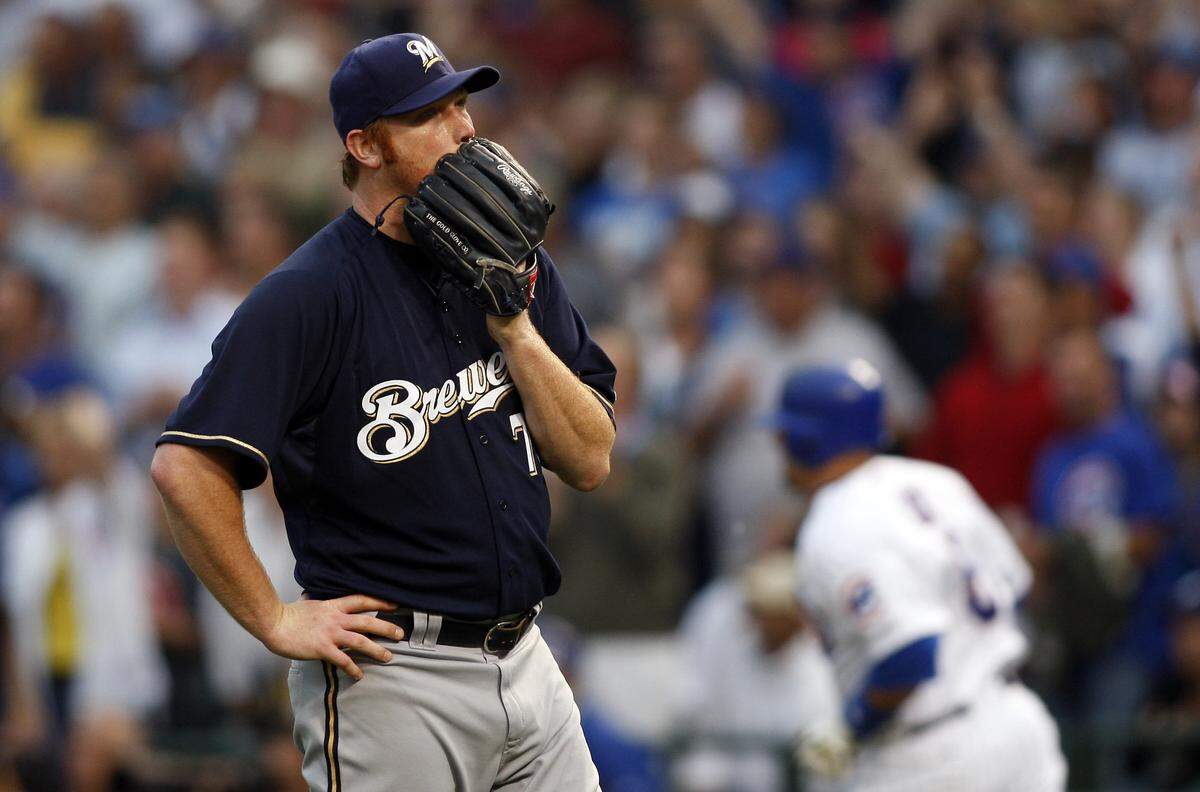 Milwaukee Brewers relief pitcher Seth McClung (73) reacts after giving up a solo home run to Chicago Cubs third baseman Jake Fox (background right) during the first inning at Wrigley Field in July 2009.