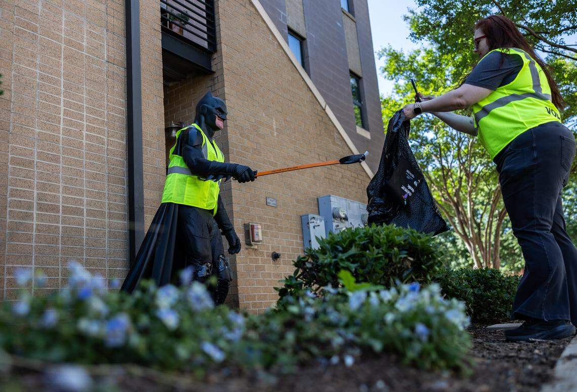 The Batman of Charlotte, D.J., volunteers to pick up trash along the Charlotte Rail Trail in Charlotte, N.C., on Saturday, April 18, 2026.