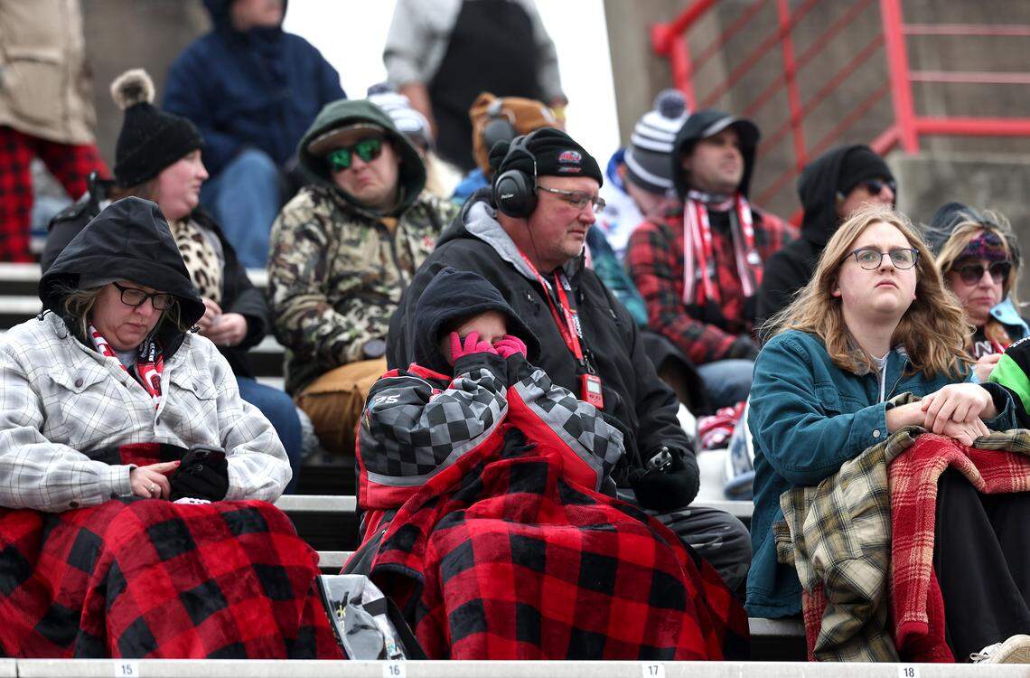 Fans sit in various levels of dress as they watch NASCAR Cup Series drivers practice at Bowman Gray Stadium in Winston-Salem on Wednesday, February 4, 2026. The stadium is hosting the Cookout Clash.