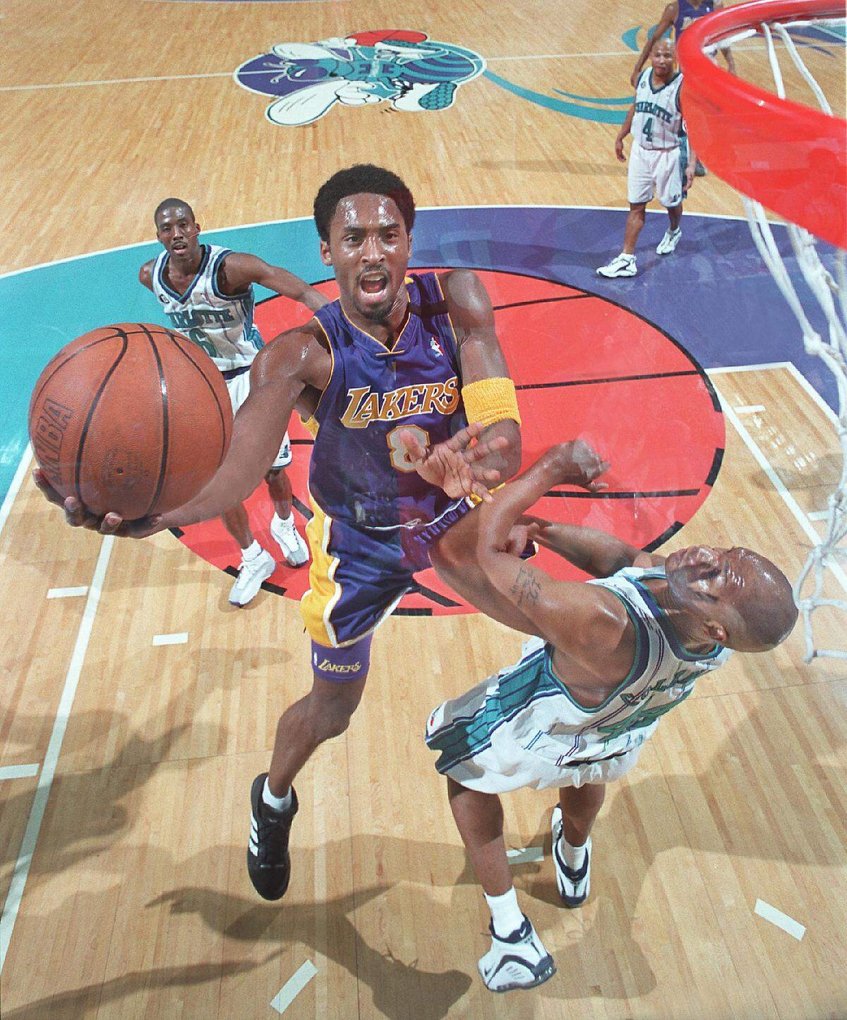 Former Los Angeles Lakers guard Kobe Bryant goes to the hoop against Derrick Coleman of the Charlotte Hornets at the Charlotte Coliseum in 2000. Bryant died Sunday in a helicopter crash.