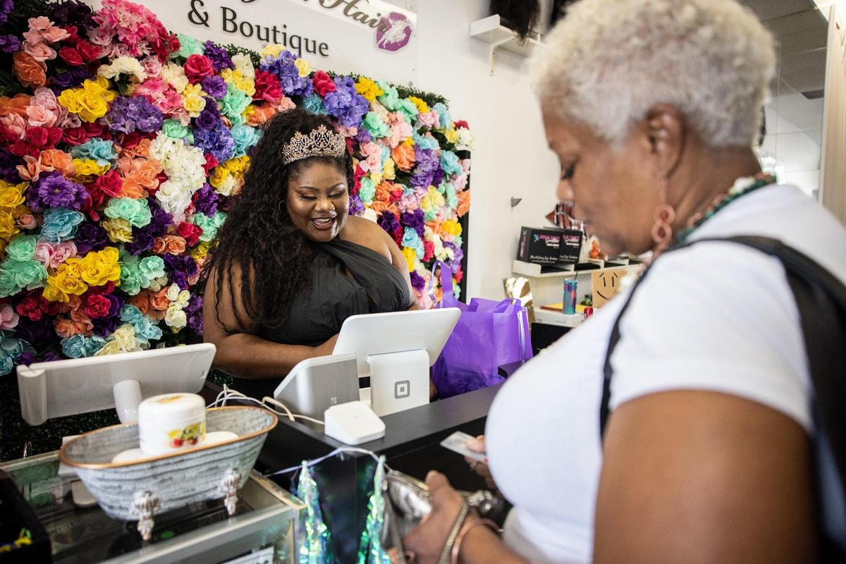 Summer Lucille, left, checks out, Nailah Ali, at her boutique, Juicy Body Goddess in Charlotte, N.C., on Wednesday, August 4, 2021.