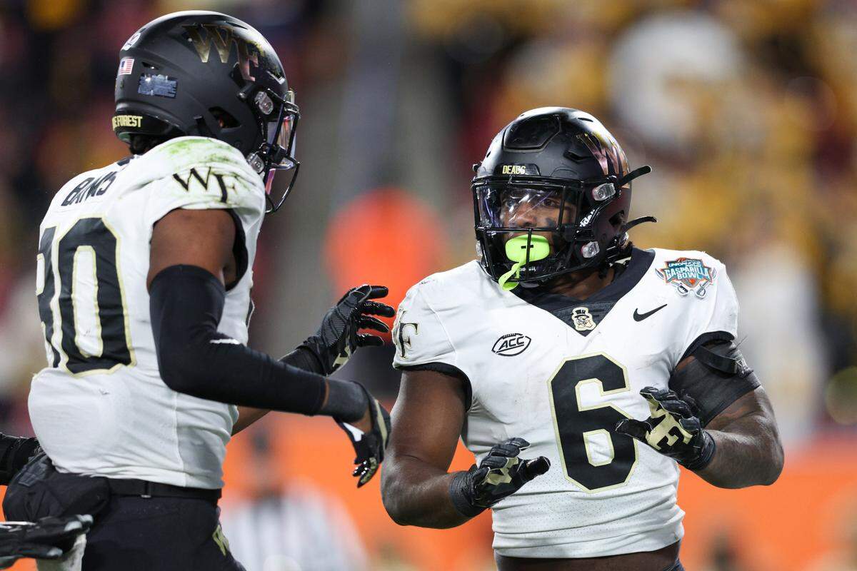 Wake Forest Demon Deacons running back Justice Ellison (6) is congratulated by defensive back Justin Simpkins (80) after scoring a touchdown against the Missouri Tigers in the second quarter in the 2022 Gasparilla Bowl at Raymond James Stadium.
