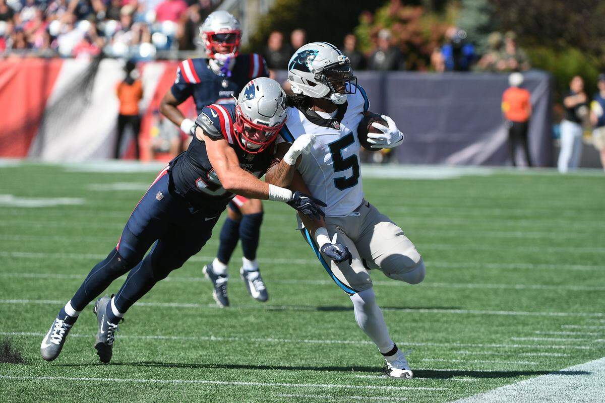 New England Patriots linebacker Elijah Ponder (91) knocks Carolina Panthers running back Rico Dowdle (5) out of bounds during Sunday’s first half at Gillette Stadium.