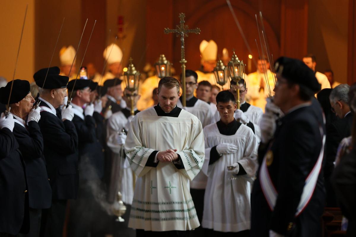 Flanked by the Knights of Columbus, Father Aaron Huber leads the recessional after the ordination of Bishop Michael T. Martin at Saint Mark Catholic Church in Huntersville on May 29, 2024.