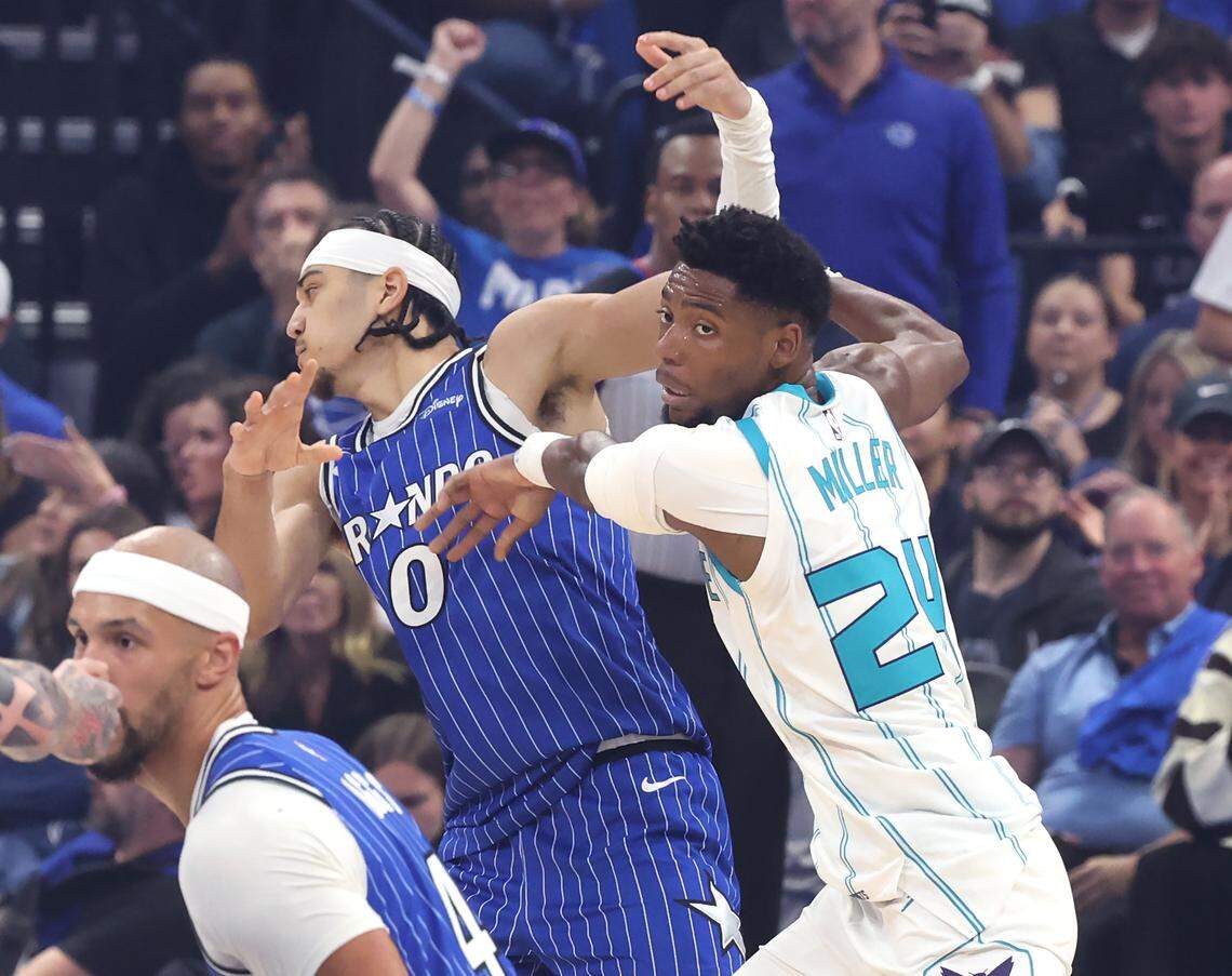 Charlotte Hornets guard Brandon Miller, right, pushes Orlando Magic guard Anthony Black, left, aside during action at Kia Center in Orlando, FL on Friday, April 17, 2026.