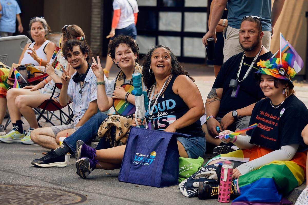 Families take in the sights and sounds during the 25th Charlotte Pride Parade in uptown Charlotte on August 17, 2025.