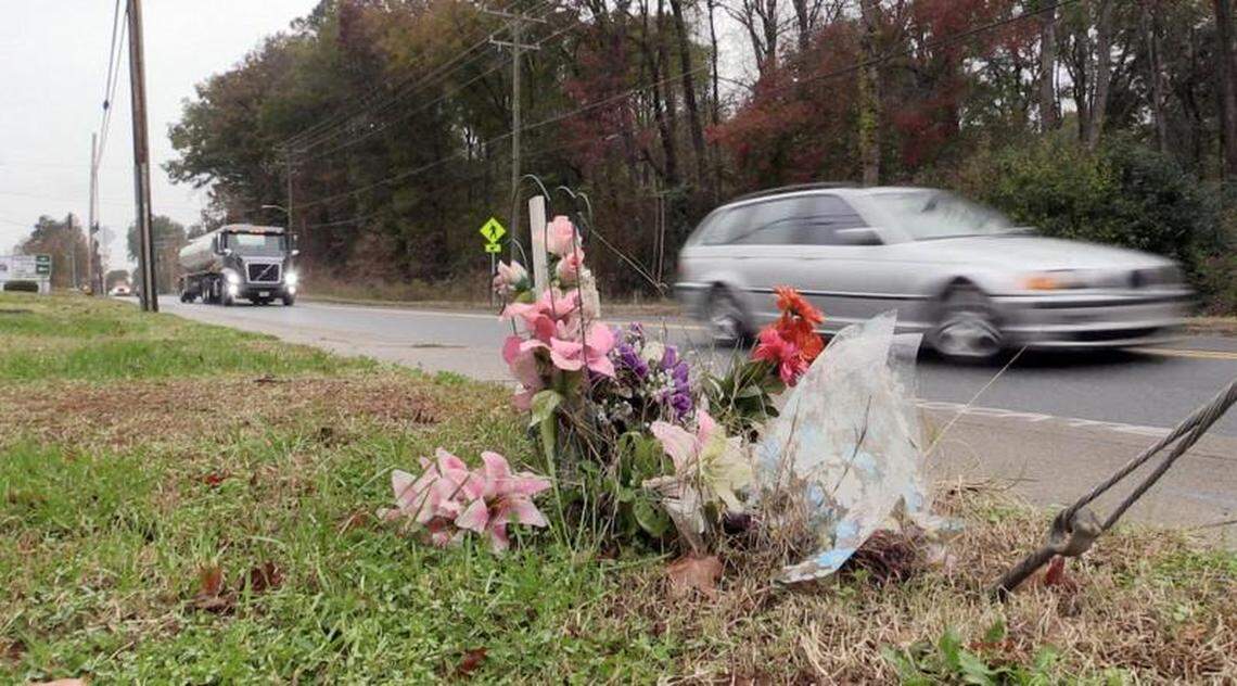 Traffic rolls by a memorial near the intersection of Moores Chapel and Tilden Roads on Wednesday, November 14, 2018. Franziska Bruckner died at the intersection in March when she was struck and killed by a car.