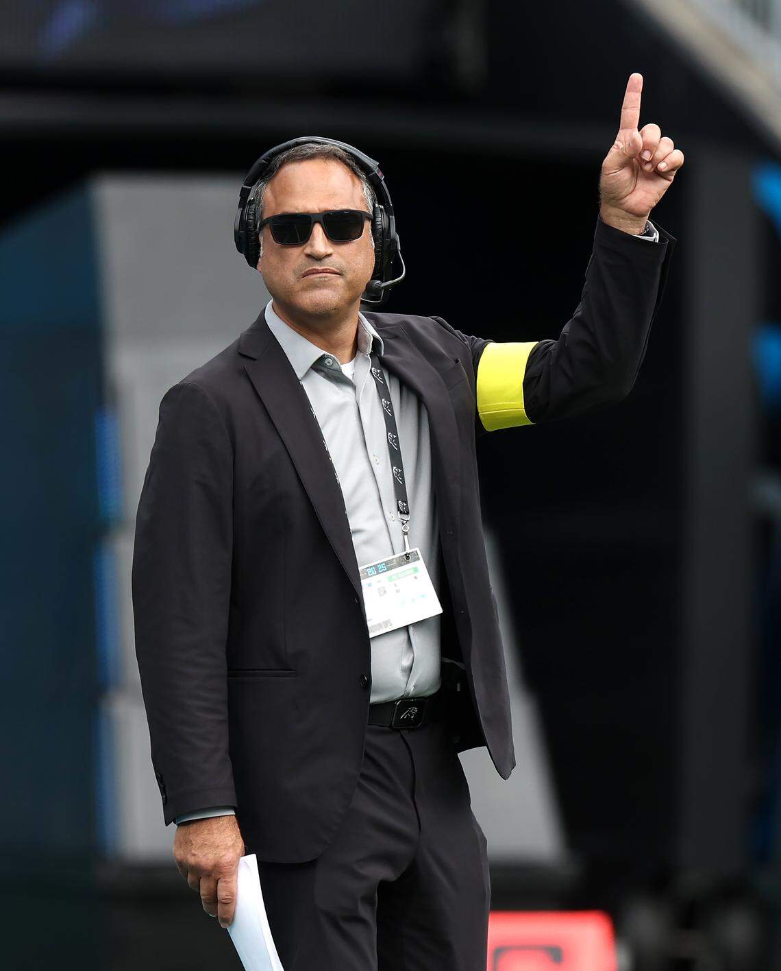 Miguel Vargas, director of entertainment for the Carolina Panthers warns personnel wanting to cross the field that skydivers are overhead on Oct. 5, 202,5 at Bank of America Stadium. The Panthers hosted the Miami Dolphins.