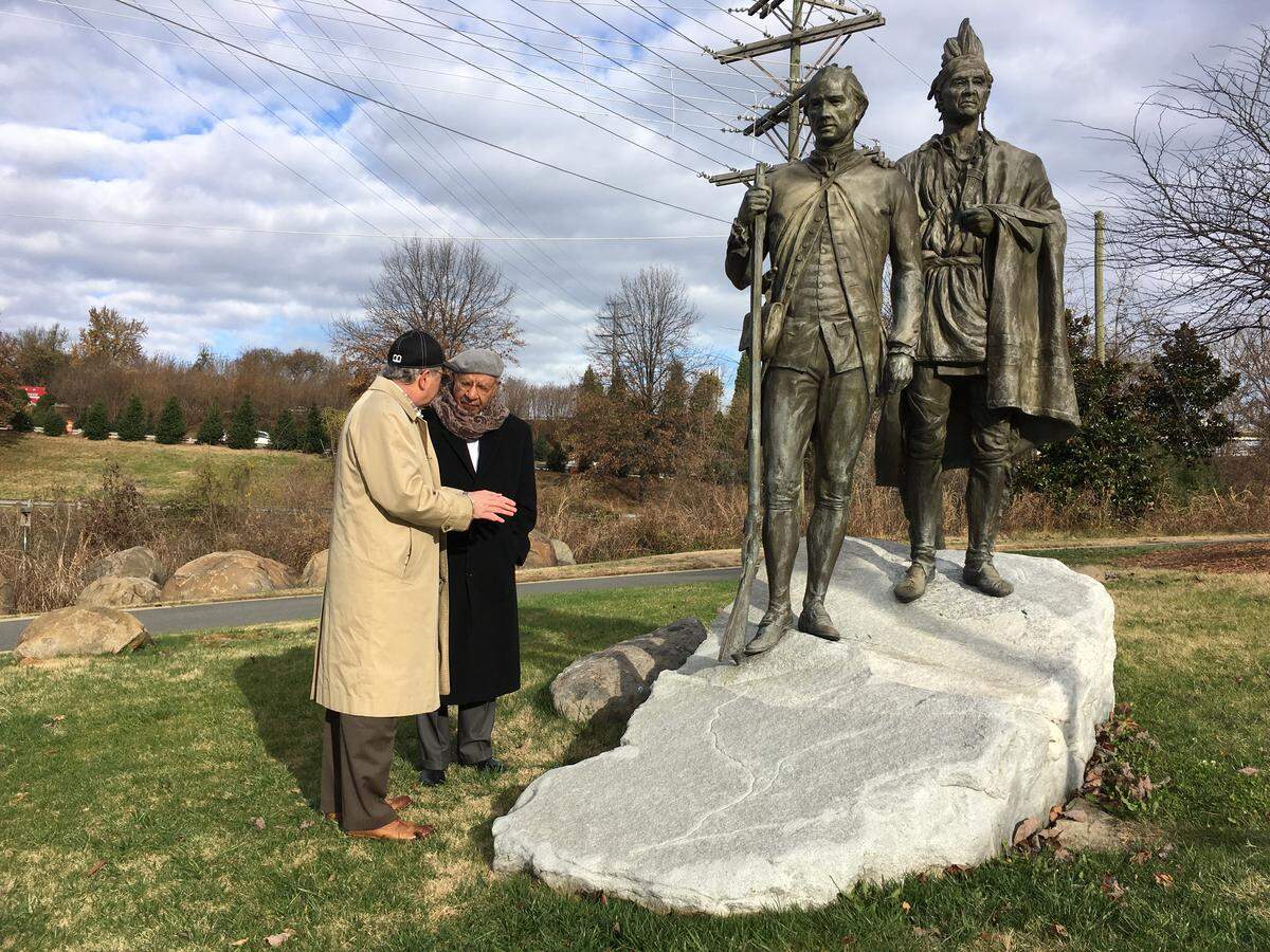 Ed Hamilton listens to Tony Zeiss as the two scout locations for the upcoming Julius Chambers statue on the Trail of History.