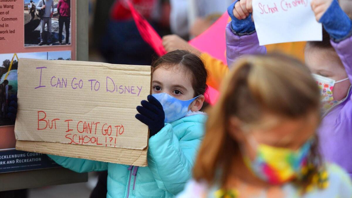 CMS students and parents gather at Midtown Park in Charlotte, NC on Tuesday, December 8, 2020 to march to reopen the schools.