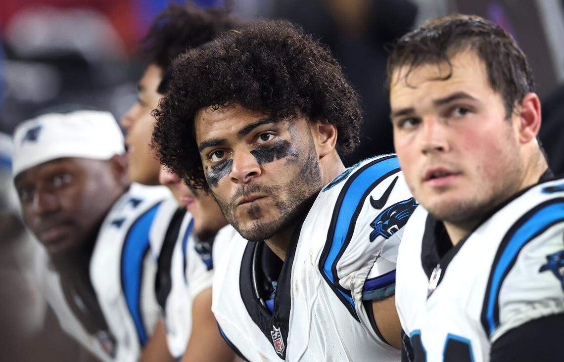 Carolina Panthers tight end Tommy Tremble, center, sits on the team’s bench during Saturday’s action against the Tampa Bay Buccaneers at Raymond James Stadium in Tampa, Florida. The Buccaneers defeated the Panthers 16-14.