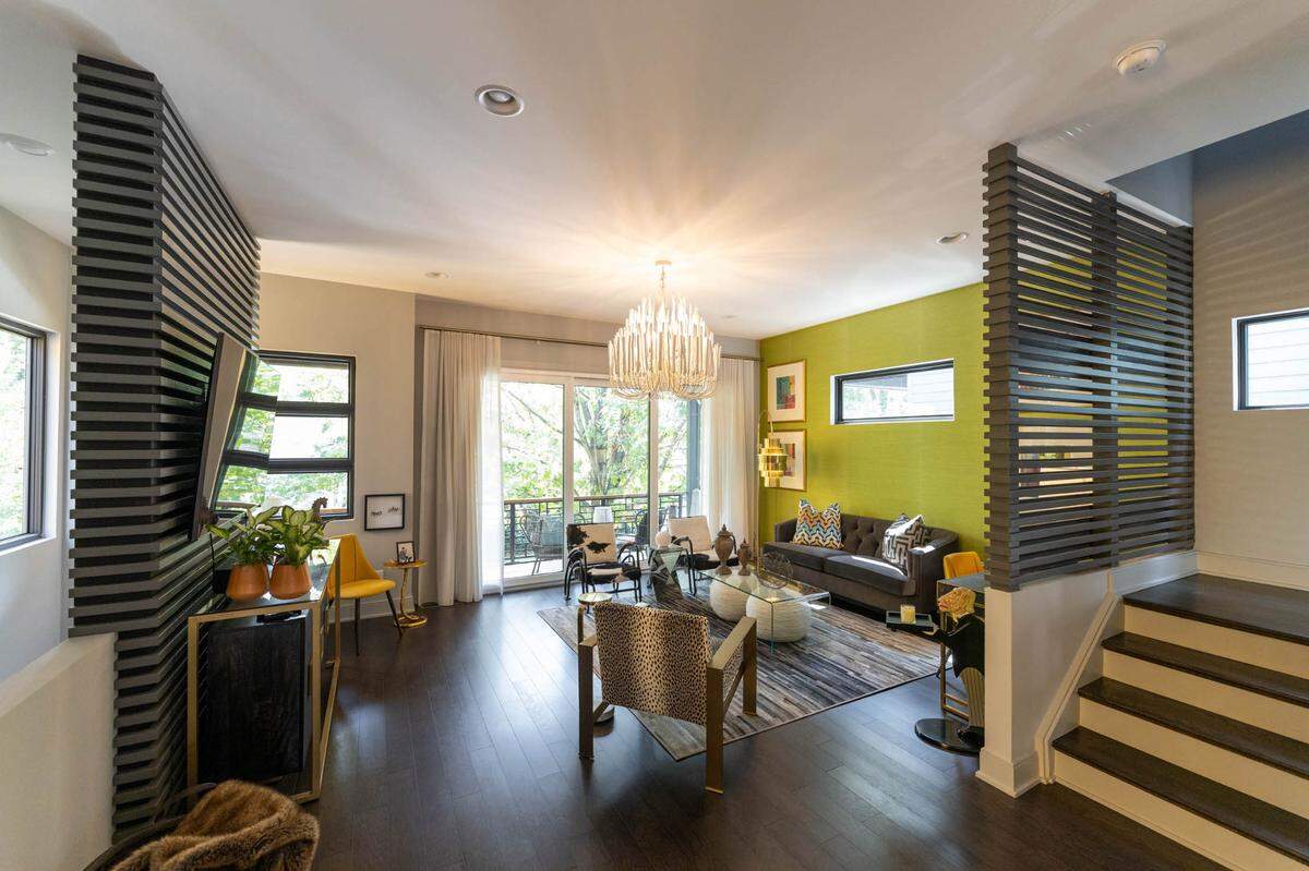 The home’s living room includes a bright green accent wall as its focal point.