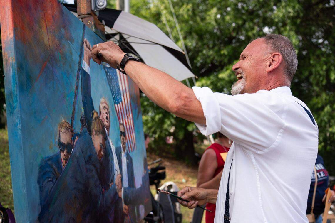 Artist Dan Nelson from Raleigh N.C. draws a painting of former President Donald Trump outside the Bojangles Coliseum in Charlotte on July 24, 2024.