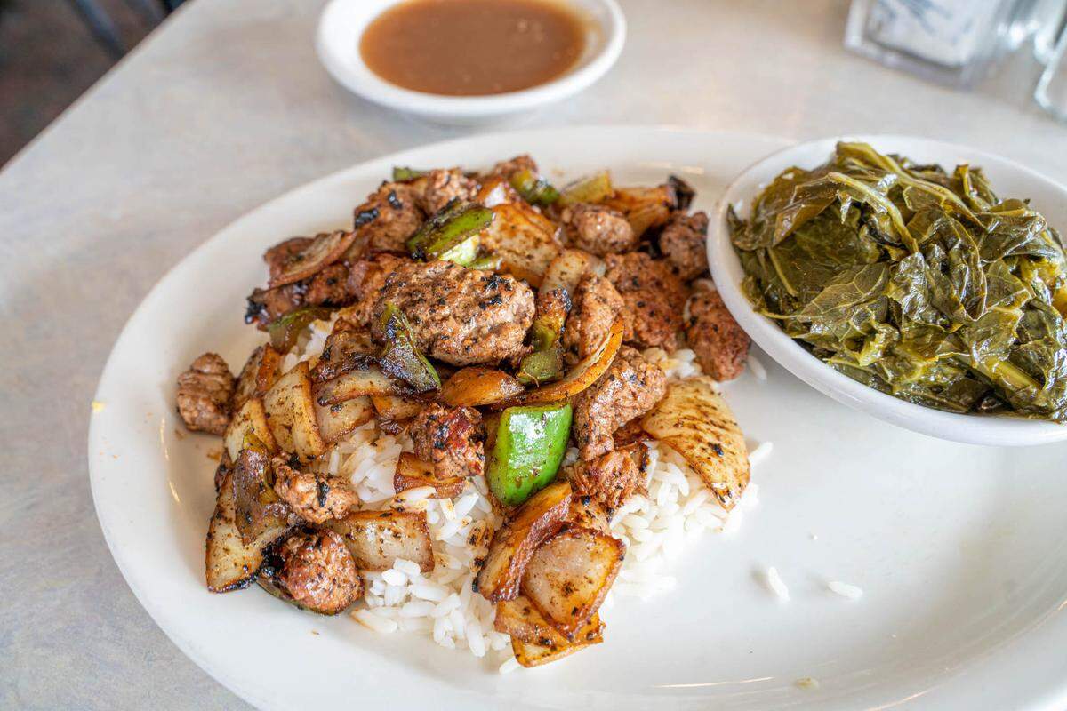 Gus’ Sir Beef serves “The Super,” fresh beef tips over rice with onions, peppers, gravy and a side of collards.
