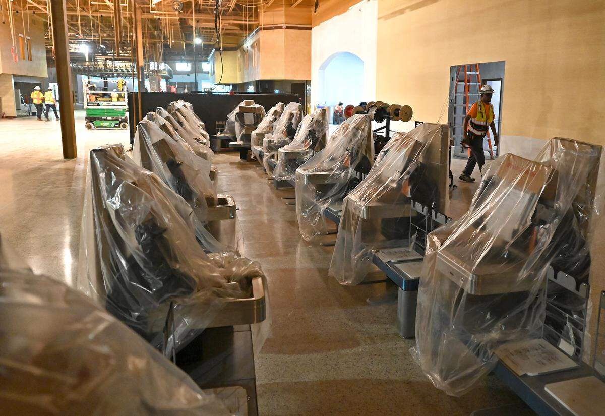 Checkout stands remain covered in the Wegmans store as construction continues on the Charlotte store during a media tour on May 21.