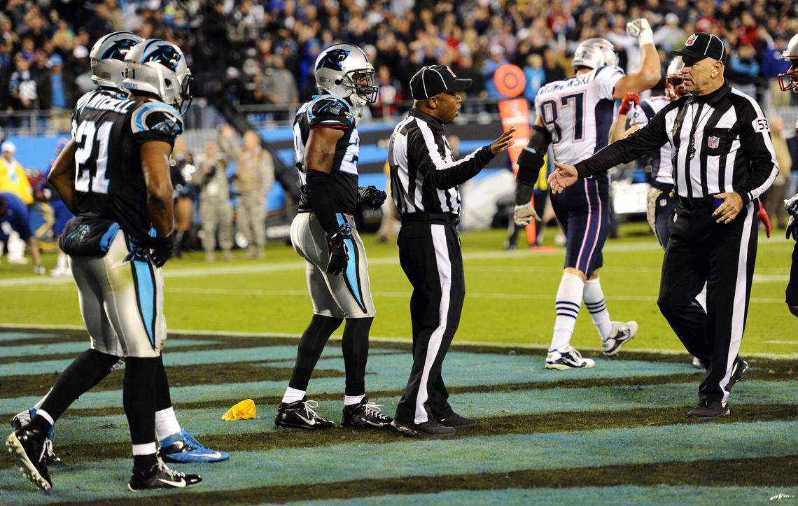 NFL officials confer after back judge Terrence Miles (111) threw a flag on the last play in the Carolina Panthers-New England Patriots game on Nov. 18, 2013, at Bank of America Stadium. The flag against the Panthers for interfering with New England tight end Rob Gronkowski on a pass from Tom Brady was later waved off because the ball was deemed uncatchable, and the Panthers won over the Patriots, 24-20.