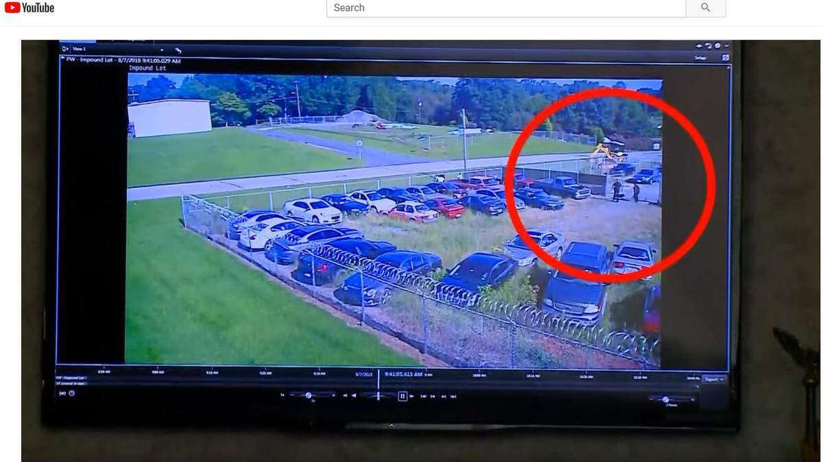 Video of the Aug. 7 encounter released to the media by police shows two officers standing in the lot when the dog suddenly dashes toward and around them before it is shot.