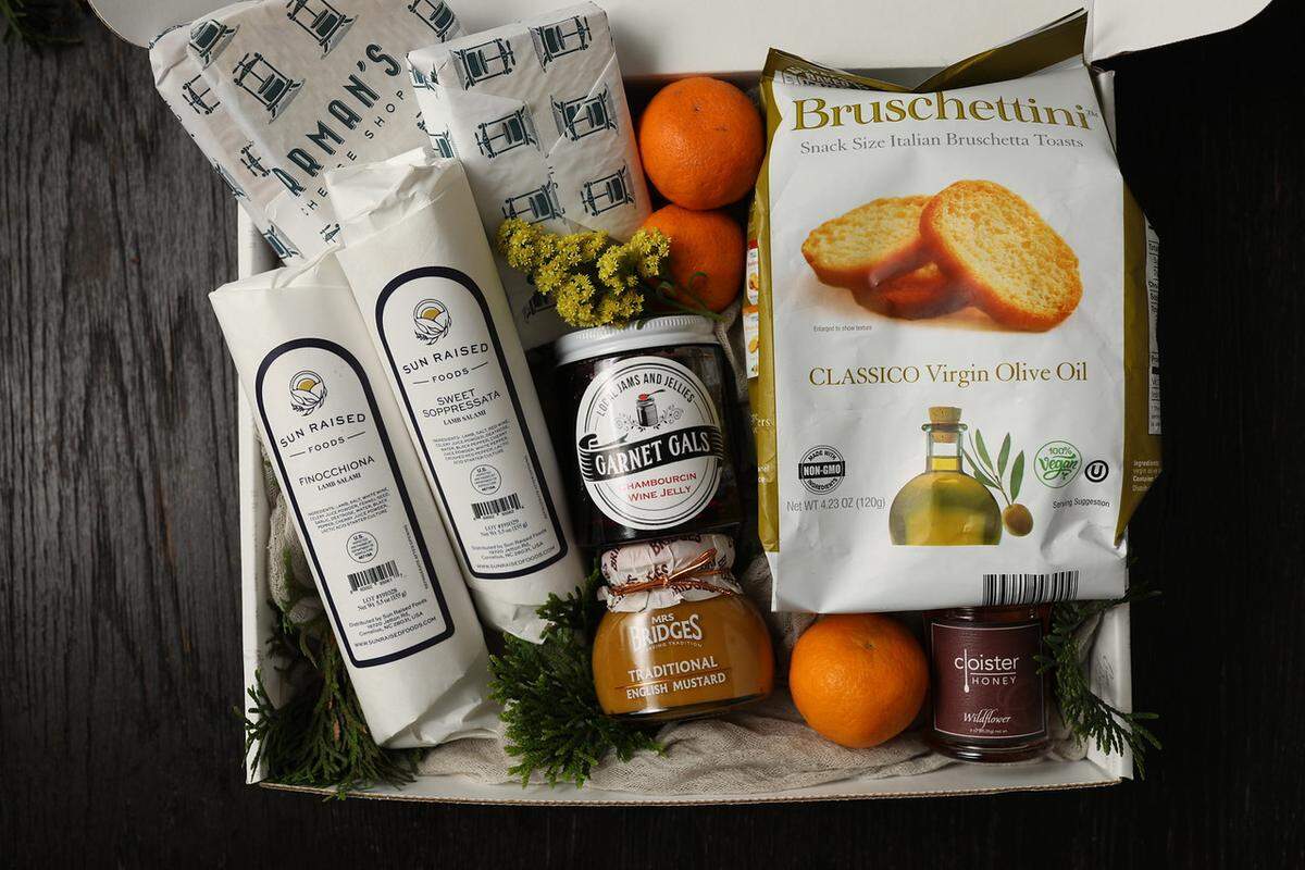 Perfect for friends who love to spend a night indoors, this charcuterie gift box offers salami, cheese, jam and honey from local vendors.